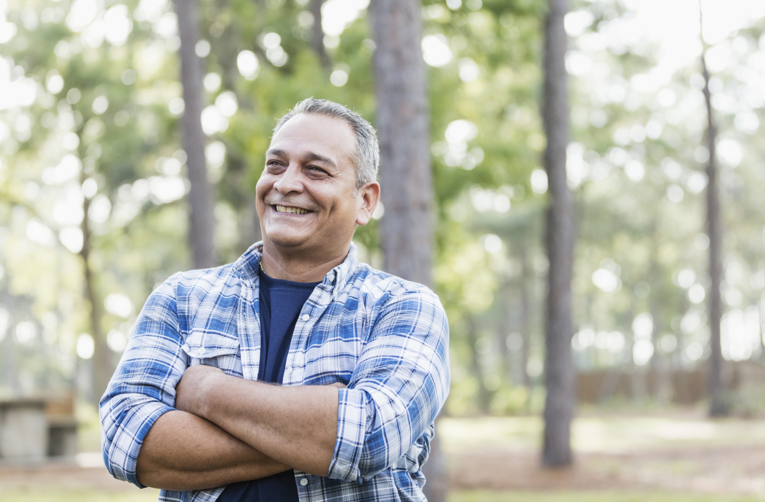 Standing outdoors, trees in the background, a man holds his arms and smiles. The Tulsa disability lawyers at Troutman & Troutman can provide answers to frequently asked questions about Social Security Disability.