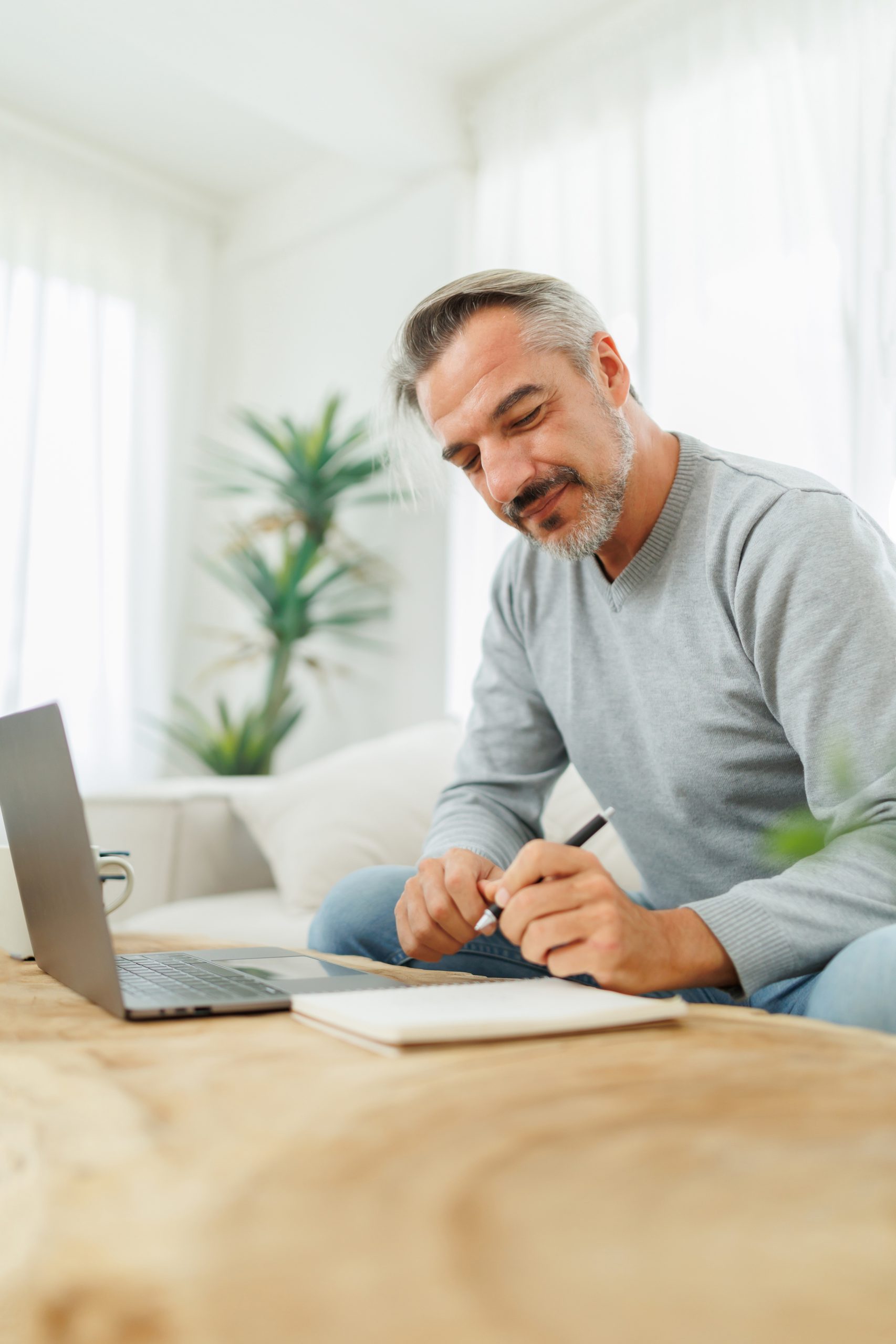 A man leans over some paperwork. The Tulsa disability attorneys at Troutman & Troutman can help you at every step of the Social Security Disability process.