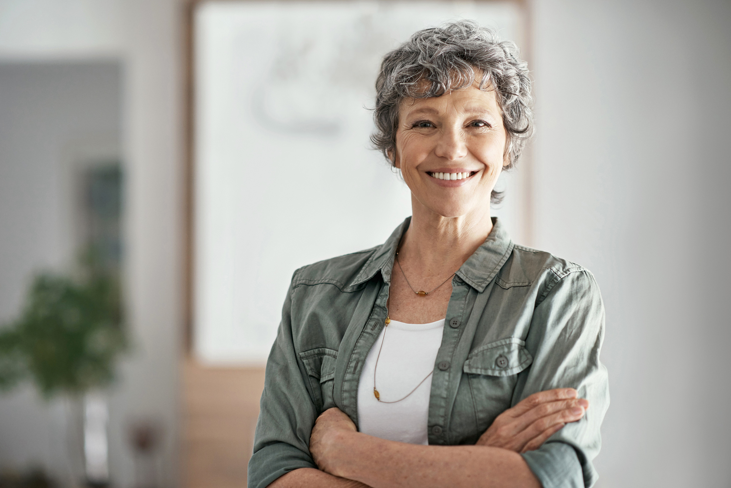 Standing with her arms folded, a woman smiles. Troutman & Troutman lawyers can help you understand how to qualify for Social Security Disability.