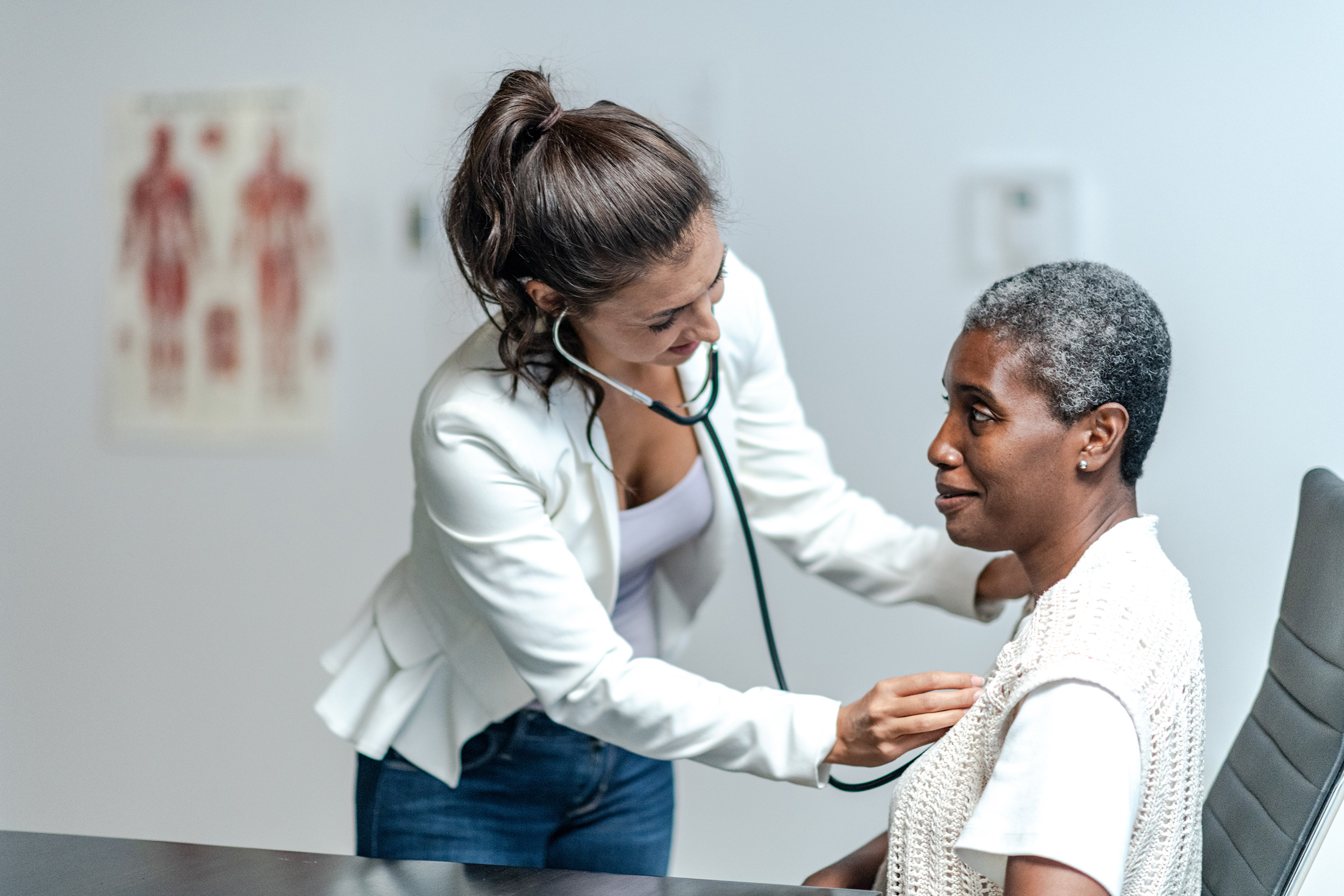 A doctor uses a stethoscope to check up on her patient. Back pay for Social Security Disability is calculated based on the official start date of your impairment that stops you from working.