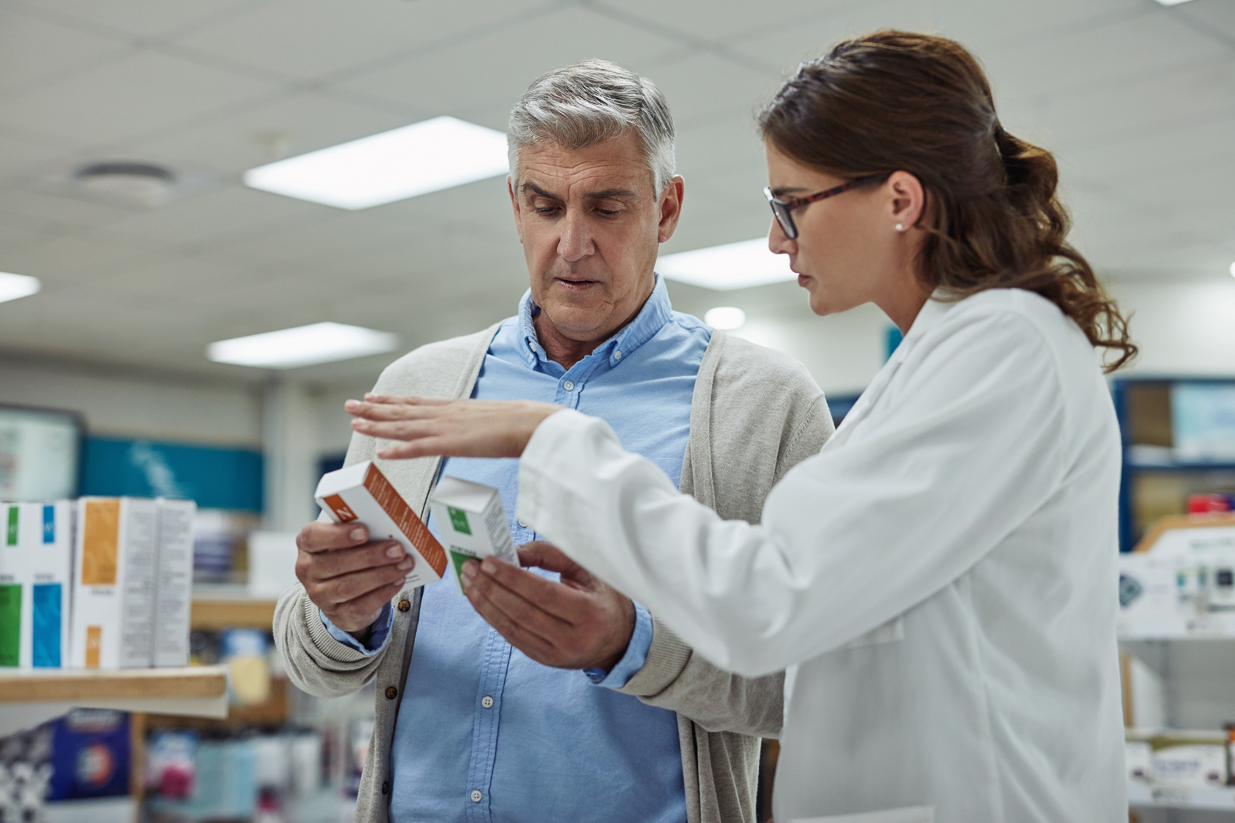 A doctor looks over medication boxes with a patient. A disability lawyer can take care of much of the legwork involved in your Social Security Disability claim.