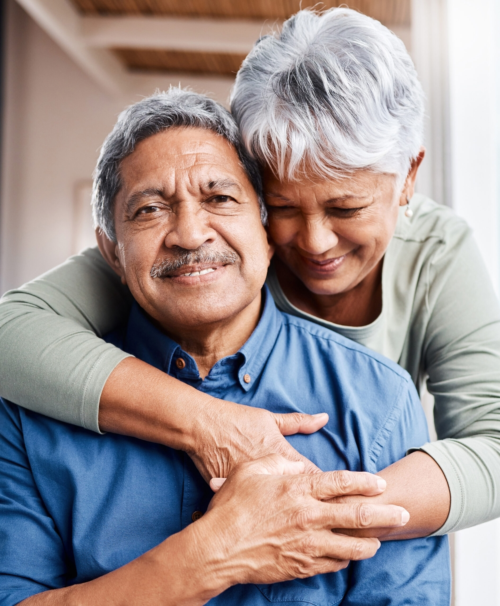 A woman hugs a man from behind as he smiles toward the camera. The Oklahoma disability benefits lawyers at Troutman & Troutman have been helping people in Muskogee for decades and have helped thousands of people across the state.