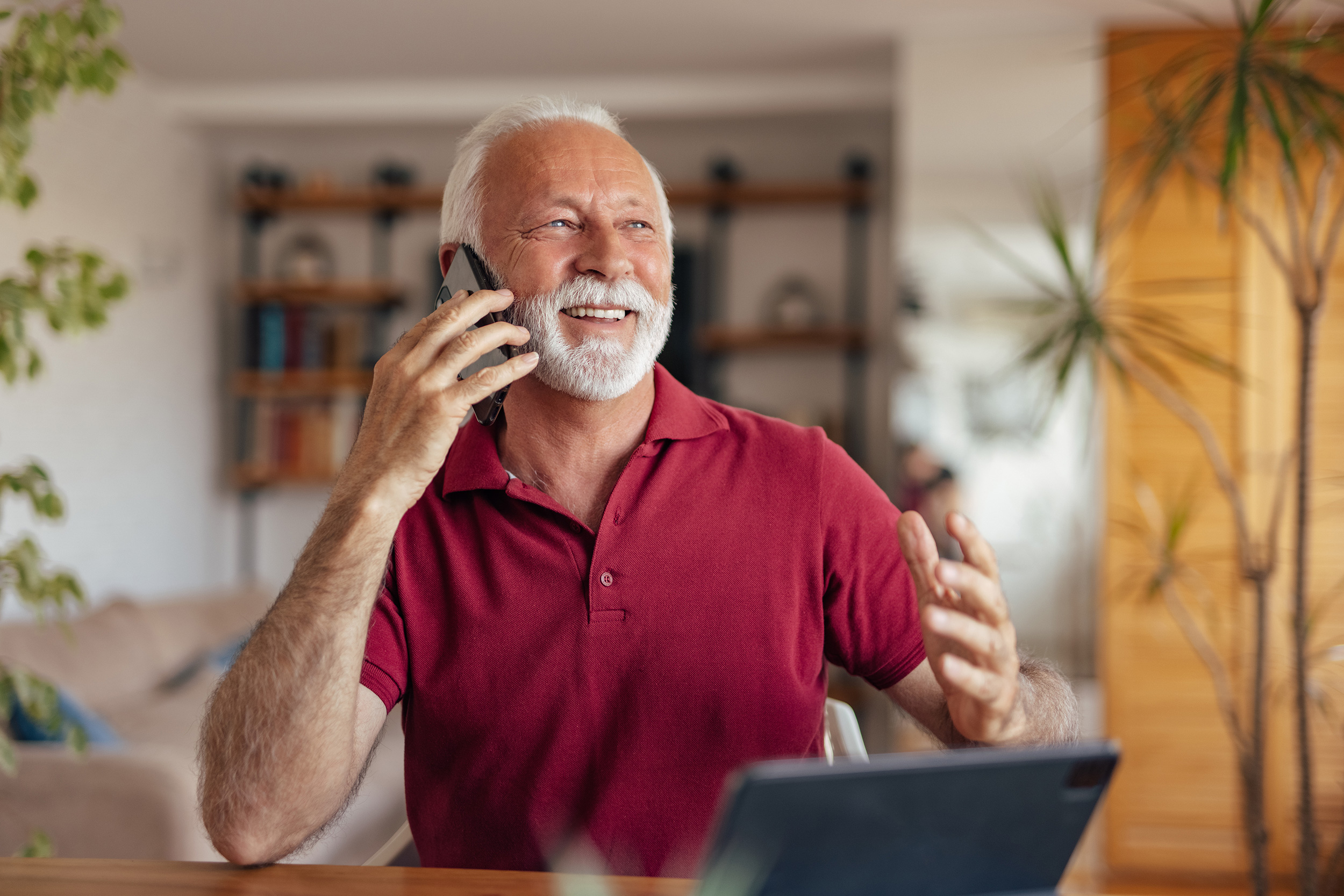 A man smiles while he talks on the phone. Troutman & Troutman disability lawyers in Bartlesville help people appeal denials of disability benefits.