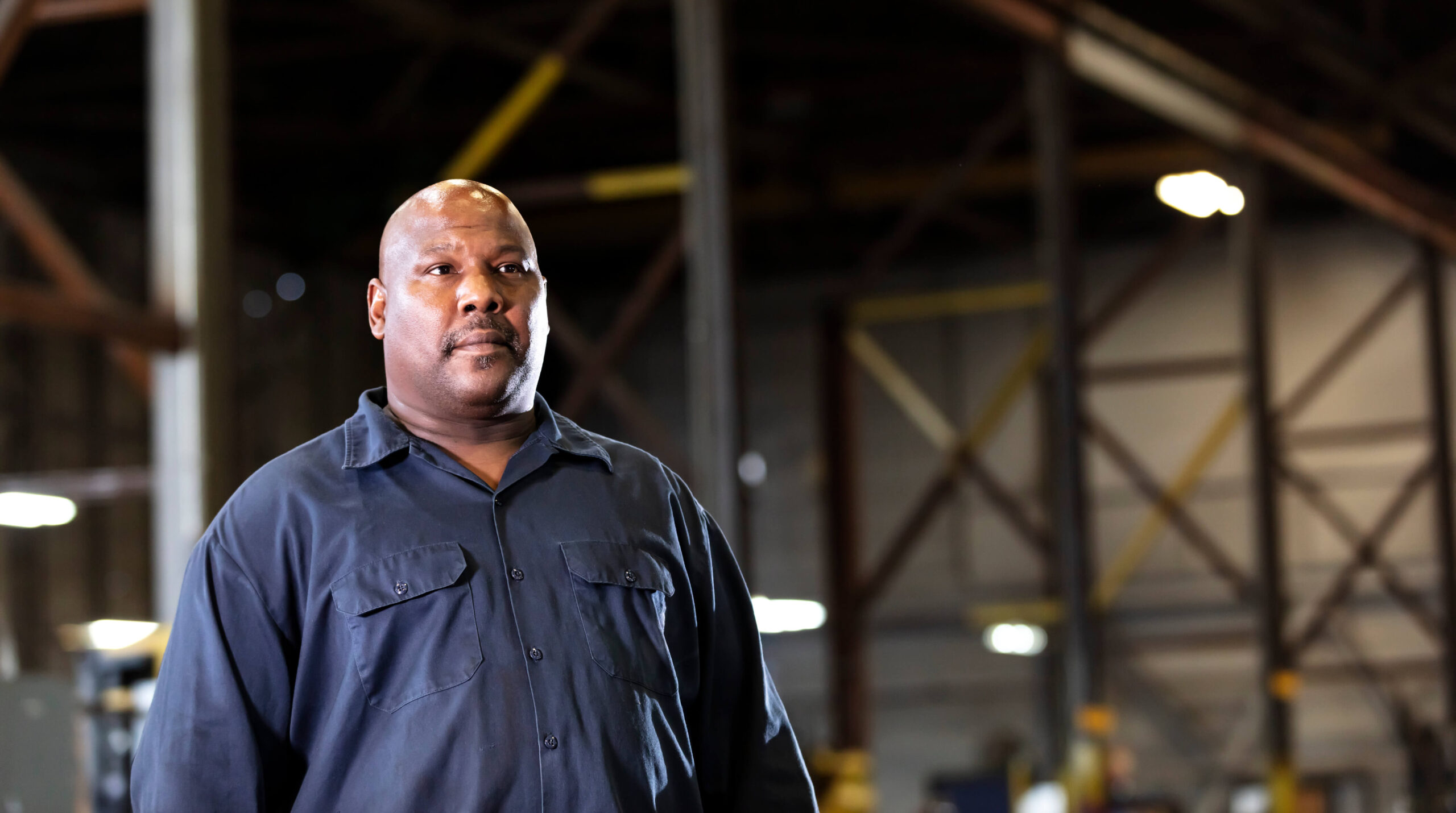 A worker stands in a warehouse. Troutman & Troutman disability lawyers answer questions from Oklahomans about disability benefits every day.