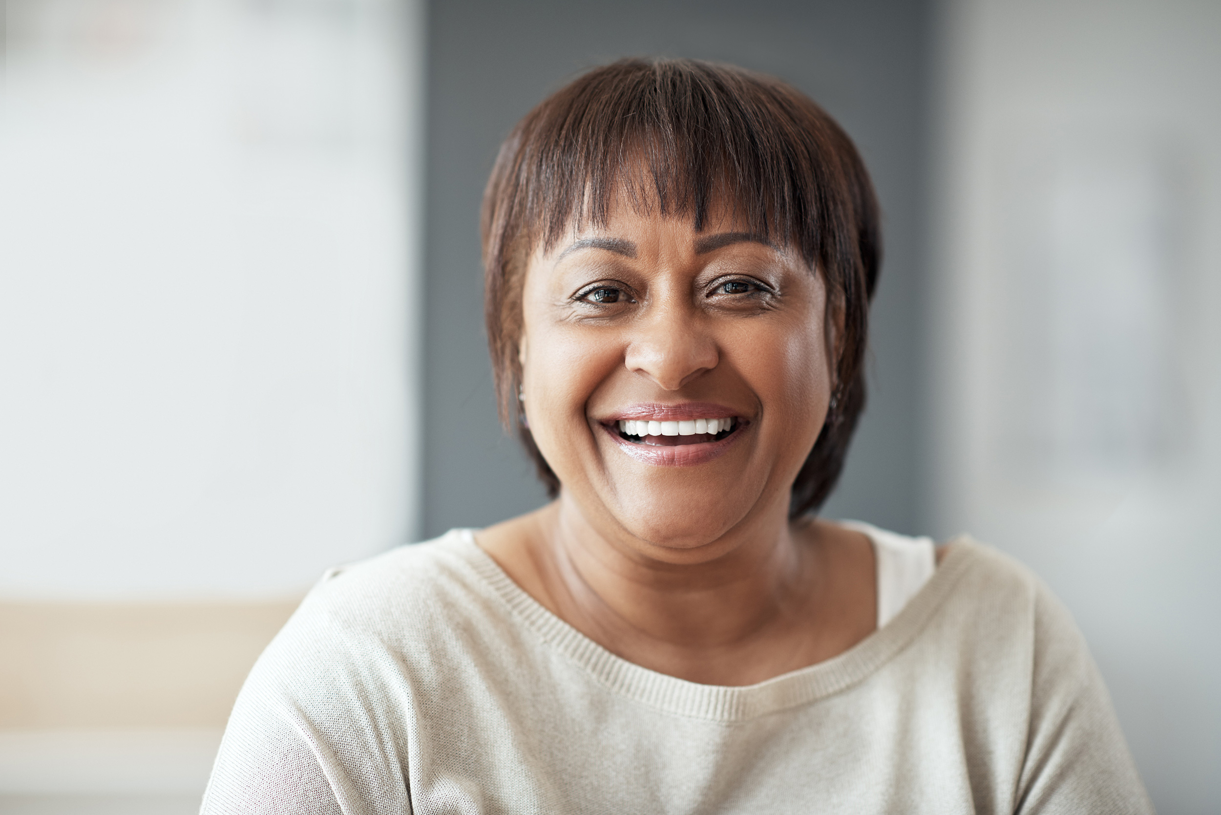 A woman smiles for the camera. Troutman & Troutman disability lawyers answer questions about disability benefits every day.